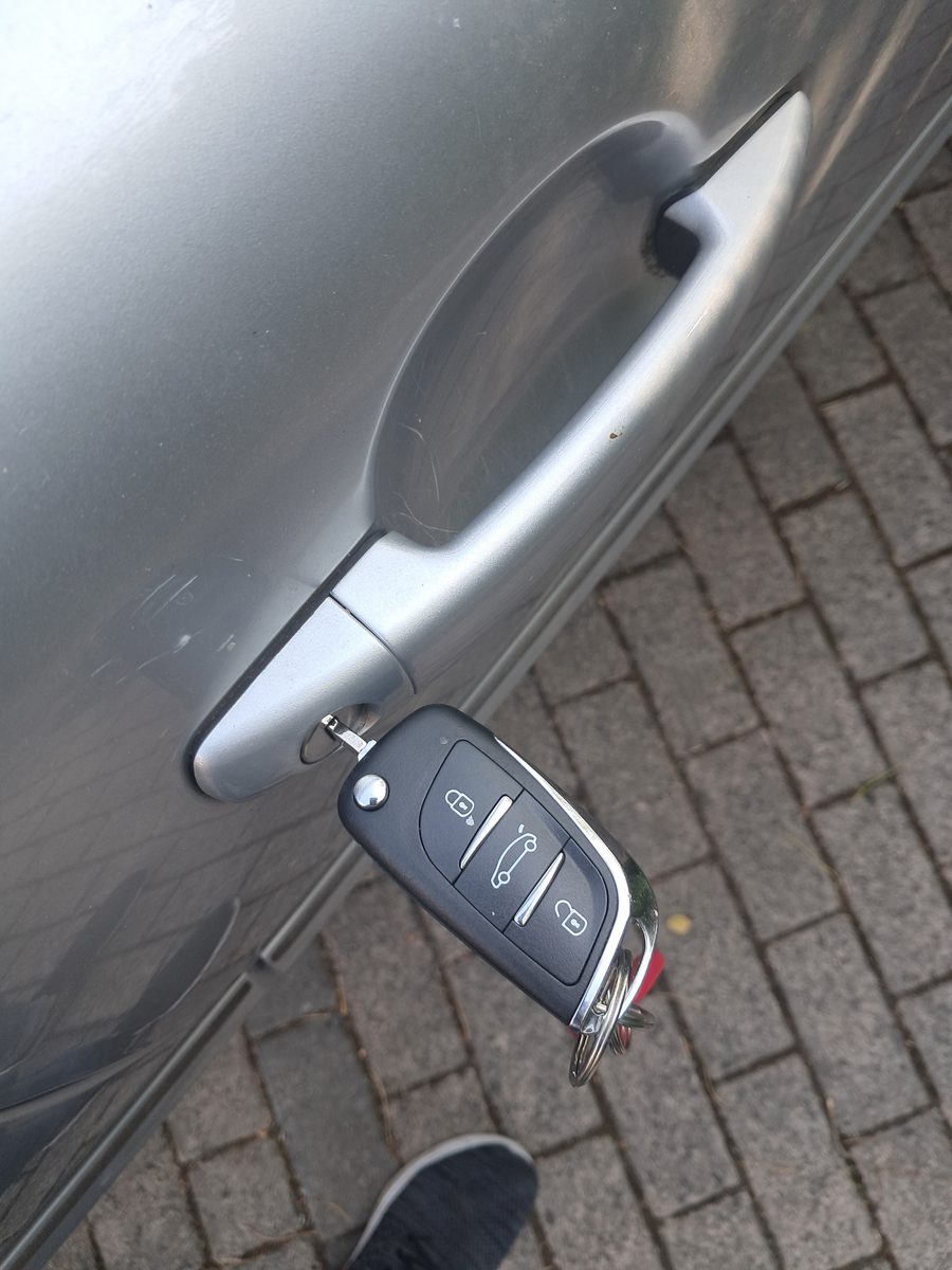 Car key in a locked car door handle during a lockout call-out